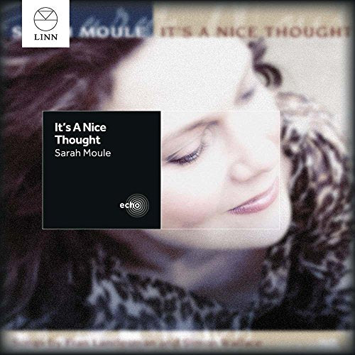 Album cover featuring a woman's face with dark hair, with text overlay.