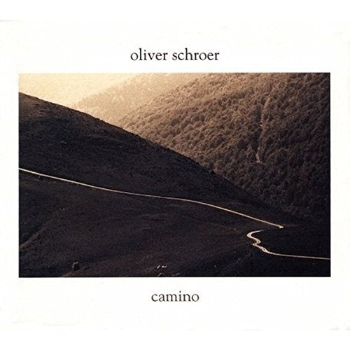 Album cover with winding road through hills, artist's name and title on white background.