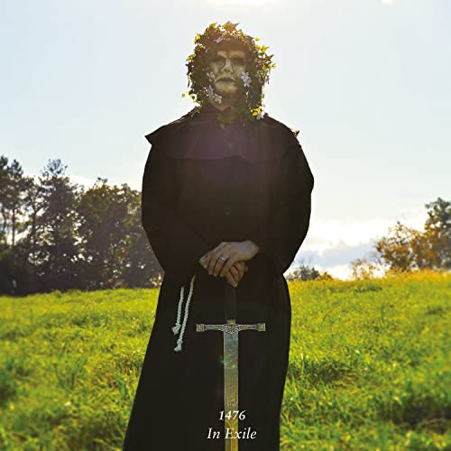 Figure in dark robes and floral headpiece holds a sword in a field.