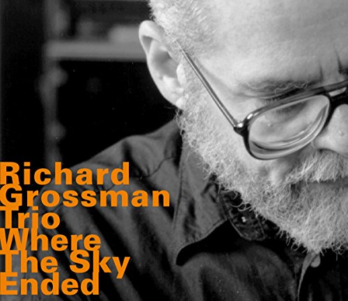 Album cover featuring a black-and-white close-up of a man with glasses and orange text.