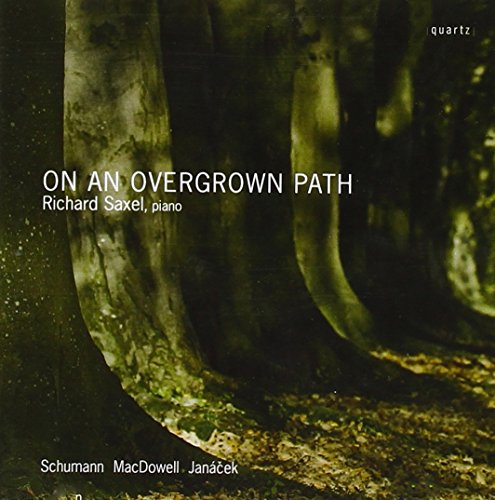 "Album cover featuring a forest scene with tree trunks and fallen leaves."