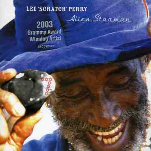 Lee 'Scratch' Perry album cover with a smiling man and a stone.