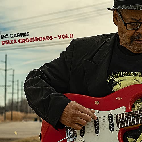 DC Carnes album cover featuring a man playing a red electric guitar.