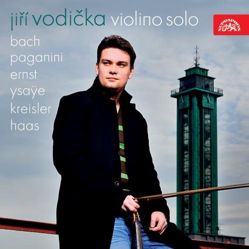 "CD cover featuring a man holding a violin bow, with a tall green tower."