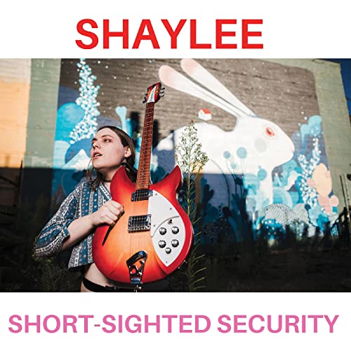 Shaylee album cover featuring a woman with a red guitar and mural.