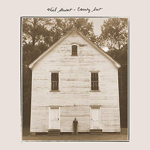 "Sepia-toned album cover featuring a man standing in front of a white wooden building."