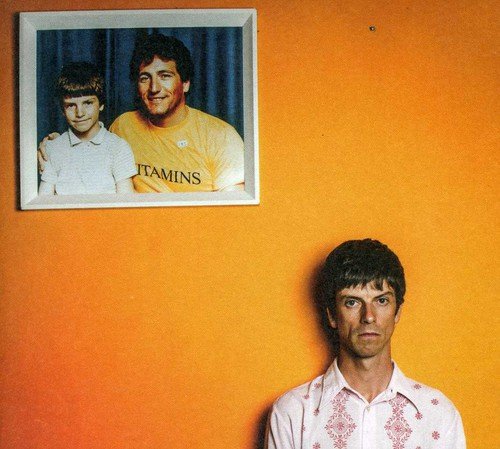 Album cover with a man and a framed photo of a man and a boy.