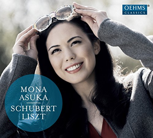 Smiling woman Mona Asuka adjusts glasses on CD cover art.