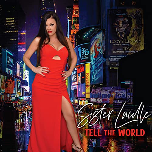 Woman in red dress stands in Times Square, album cover art.