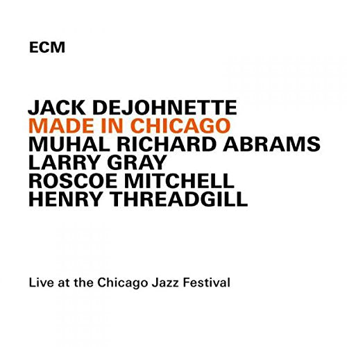 "Album cover with white background, black and orange text listing the artist and musicians."