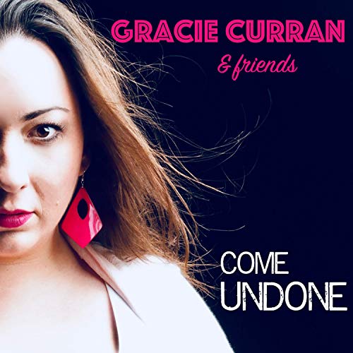 Album cover featuring a woman with brown hair and pink earrings against a dark background.