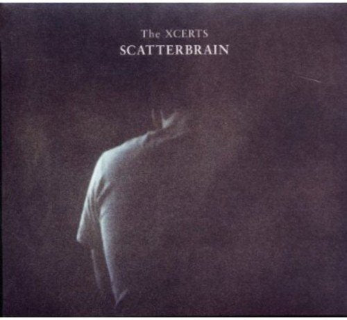 "Album cover with a person in a white shirt, back turned, on a dark background."