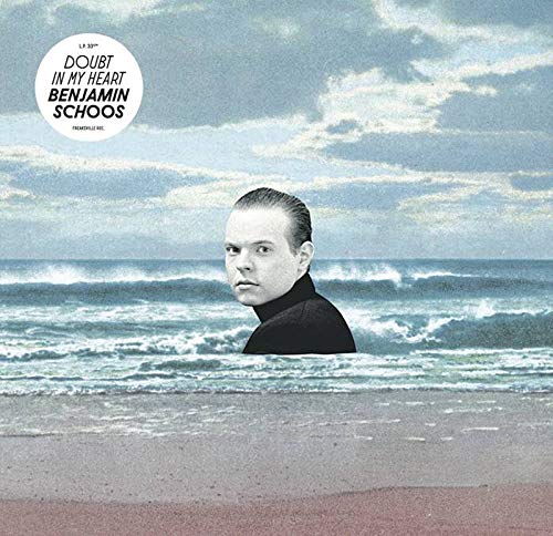 "Album cover with a man standing in the ocean, wearing a black turtleneck."