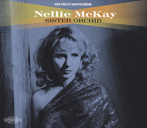 "Nellie McKay album cover featuring a woman in a sparkly dress leaning against a wooden beam."