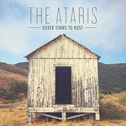 "Album cover featuring a weathered wooden shed in a rural landscape."