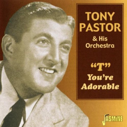 CD cover with a man in a suit and tie, smiling, on a brown background.