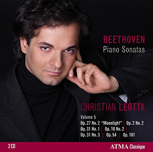 "CD cover featuring a man in a black turtleneck and jacket against a dark background."