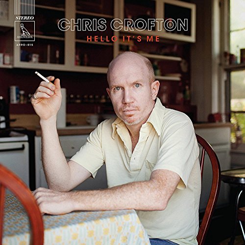 Vinyl album cover featuring a man sitting at a table, holding a cigarette.
