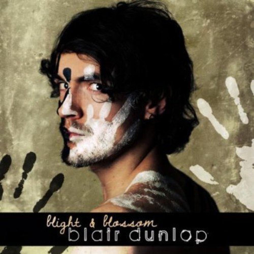 "Album cover featuring a man with black and white paint on his face."