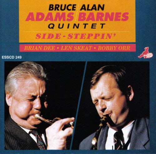 "Album cover with two men playing instruments, blue background, and yellow and pink text."