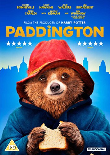 Paddington bear with a red hat, holding a sandwich, against a city skyline.