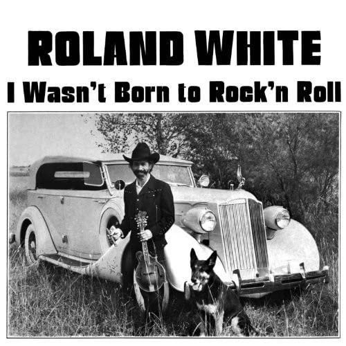 Black and white album cover featuring a man with a guitar and dog.