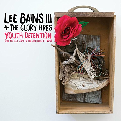 Album cover: wooden box containing shoe, rose, and wires, with artist and title text.