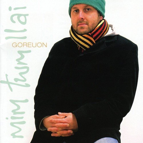 "Man in black coat, green beanie, and striped scarf on a white background."