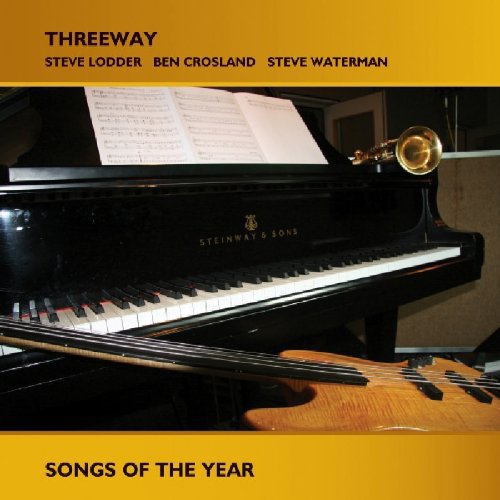 A CD album cover featuring a piano, trumpet, and guitar on a gold background.