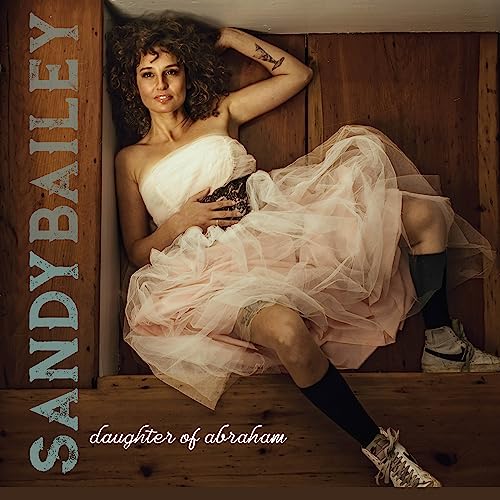 Sandy Bailey album cover: woman in tulle dress leaning against wood.