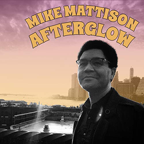 "Album cover featuring a man in front of a city skyline at sunset."