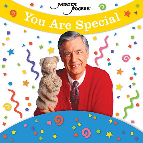 "Mister Rogers in red cardigan holding a teddy bear, surrounded by colorful confetti."