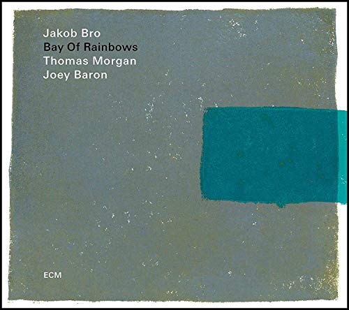 A CD album cover with a grey background and a blue rectangle.