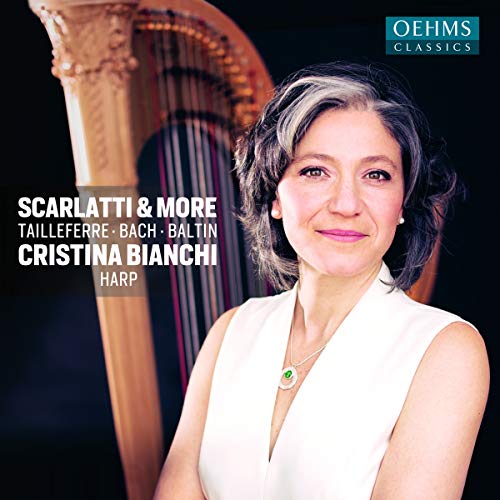 CD cover featuring a smiling woman in white with a harp behind her.
