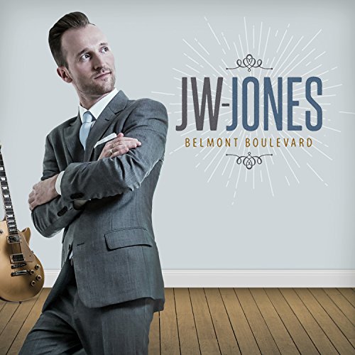 Album cover featuring a man in a grey suit with a guitar.
