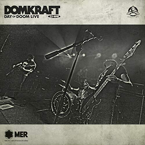 CD cover for Domkraft’s “Day Of Doom Live” featuring a stage and musicians.