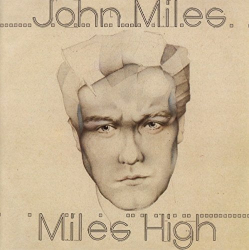 Album cover with a man's face, wearing a paper hat, on a beige background.