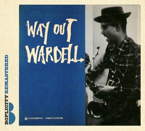 "Album cover with man playing saxophone, wearing hat, and plaid shirt, on blue and beige background."