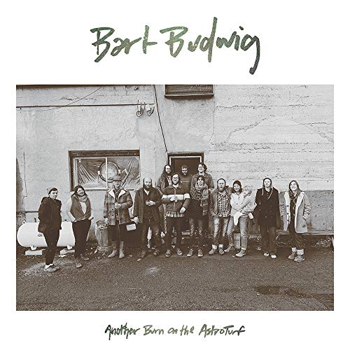 "Black and white vinyl album cover featuring a group of people standing outside a building."