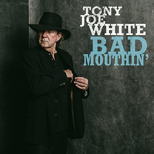 "Tony Joe White album cover featuring a man in black clothing and hat against a dark background."