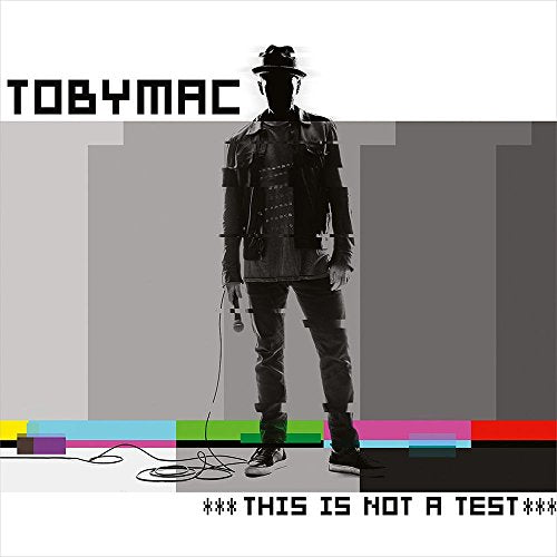 Black and white image of a man in a hat with colorful bars below.