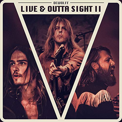 "Album cover with three men, one holding a guitar, in a triangular frame."