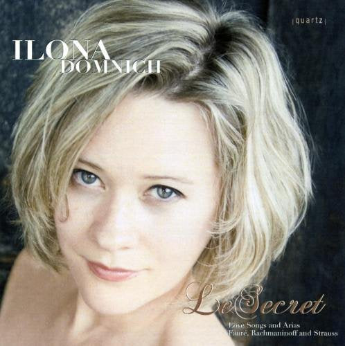 "CD cover featuring a blonde woman with blue eyes against a dark background."