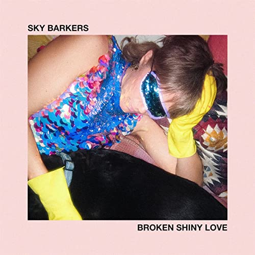 CD cover: person with dog, wearing colorful clothing and headphones.