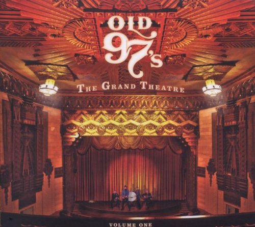 "CD cover featuring a stage with a band and ornate theater interior."