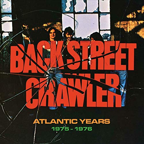 "Album cover with broken glass and band members, titled 'Back Street Crawler'."