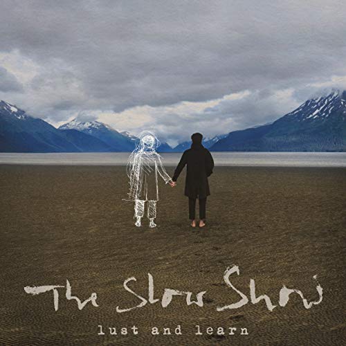 The image depicts a man and woman holding hands, with the man being transparent and wireframe-like, while the woman is solid. The text "The Slow Show" is written in a handwritten-style font at the bottom of the image, with "lust and learn" written below it in smaller text. The background features a body of water, mountains, and a cloudy sky. Alt text: Man and wireframe figure holding hands by a lake and mountains.