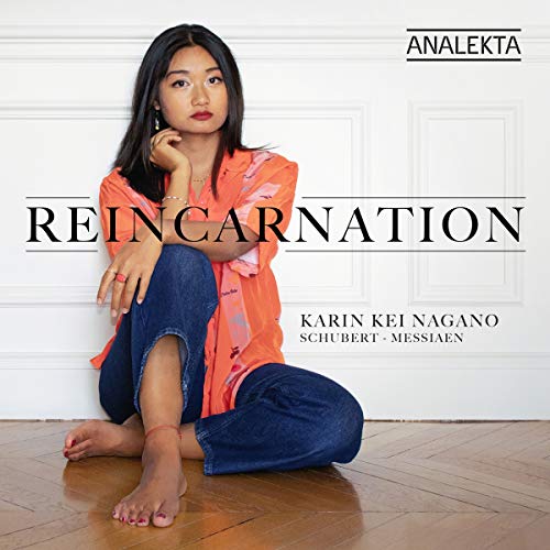 CD cover featuring a woman sitting on a wooden floor against a white paneled wall.