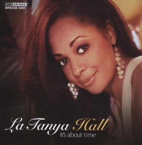 "Album cover featuring a woman with dark hair and large earrings, smiling."