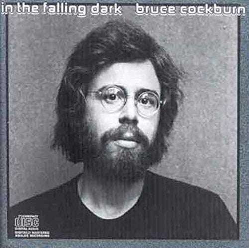 Black and white album cover with a man wearing glasses and a dark shirt.